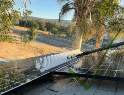 A pristine solar panel being cleaned with water spray