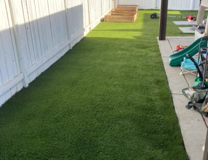 A well-maintained backyard with pristine artificial grass and a clean environment.