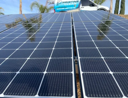 Close-up of solar panels reflecting sunlight with Pristine Clean branding in the background.