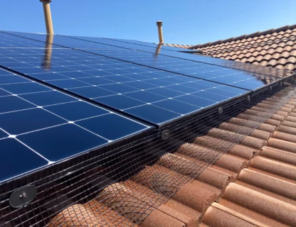 Rooftop solar panels showcasing pristine cleanliness with a backdrop of a bright sky.